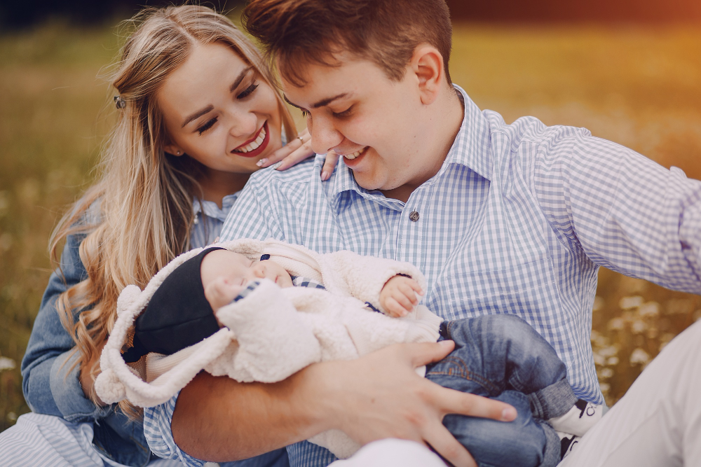 A happy couple with their baby, showing love and connection.